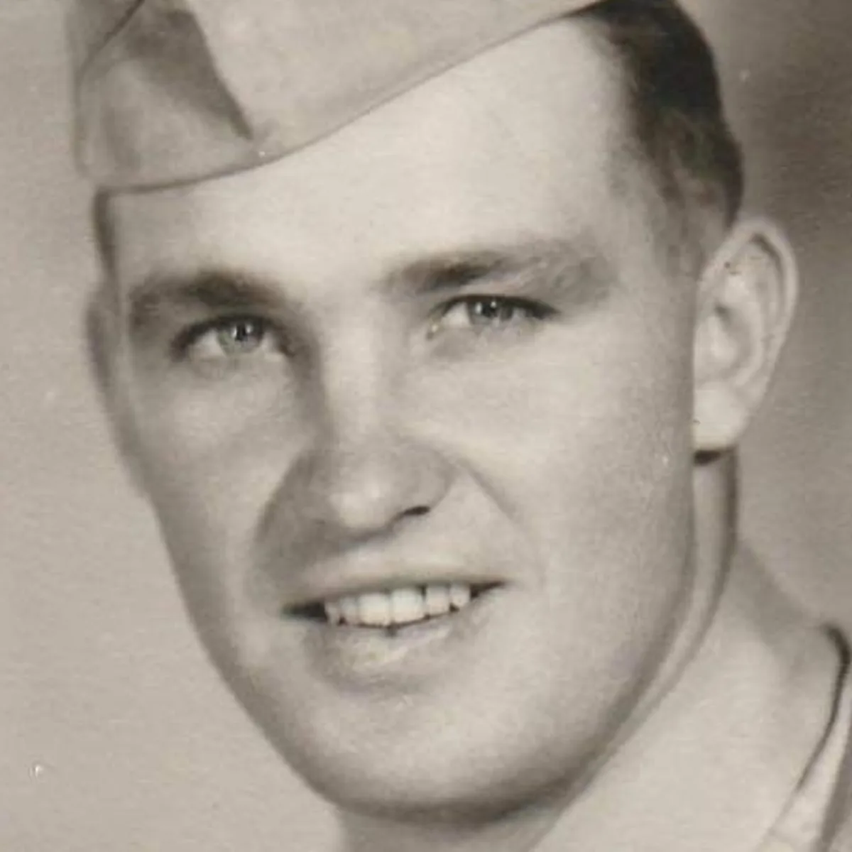 Faded vintage portrait of a young soldier — the original scan